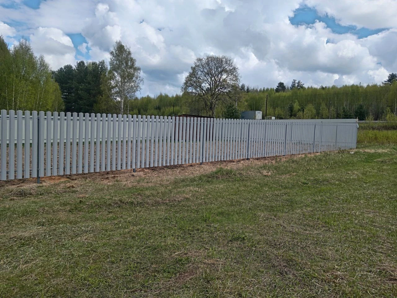 Белое ограждение из евроштакетника на открытом участке